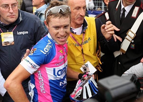 A satisfied-looking Cunego surveys the media attention around him