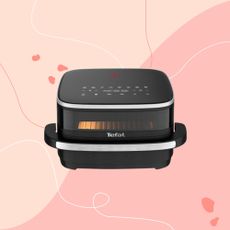 Tefal's pizza sized air fryer on a pink Ideal Home style background