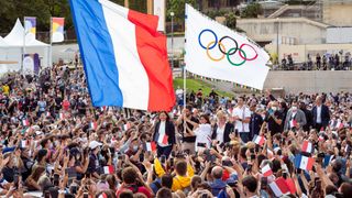 French flag and Olympic flags in a crowd of people for the 2024 summer games