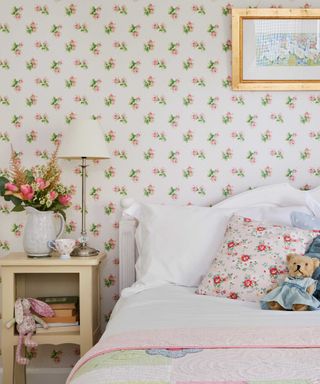 floral wallpaper in a country style bedroom with neutral bed covers