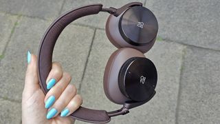 Bang & Olufsen Beoplay H95 review: woman holding headphones