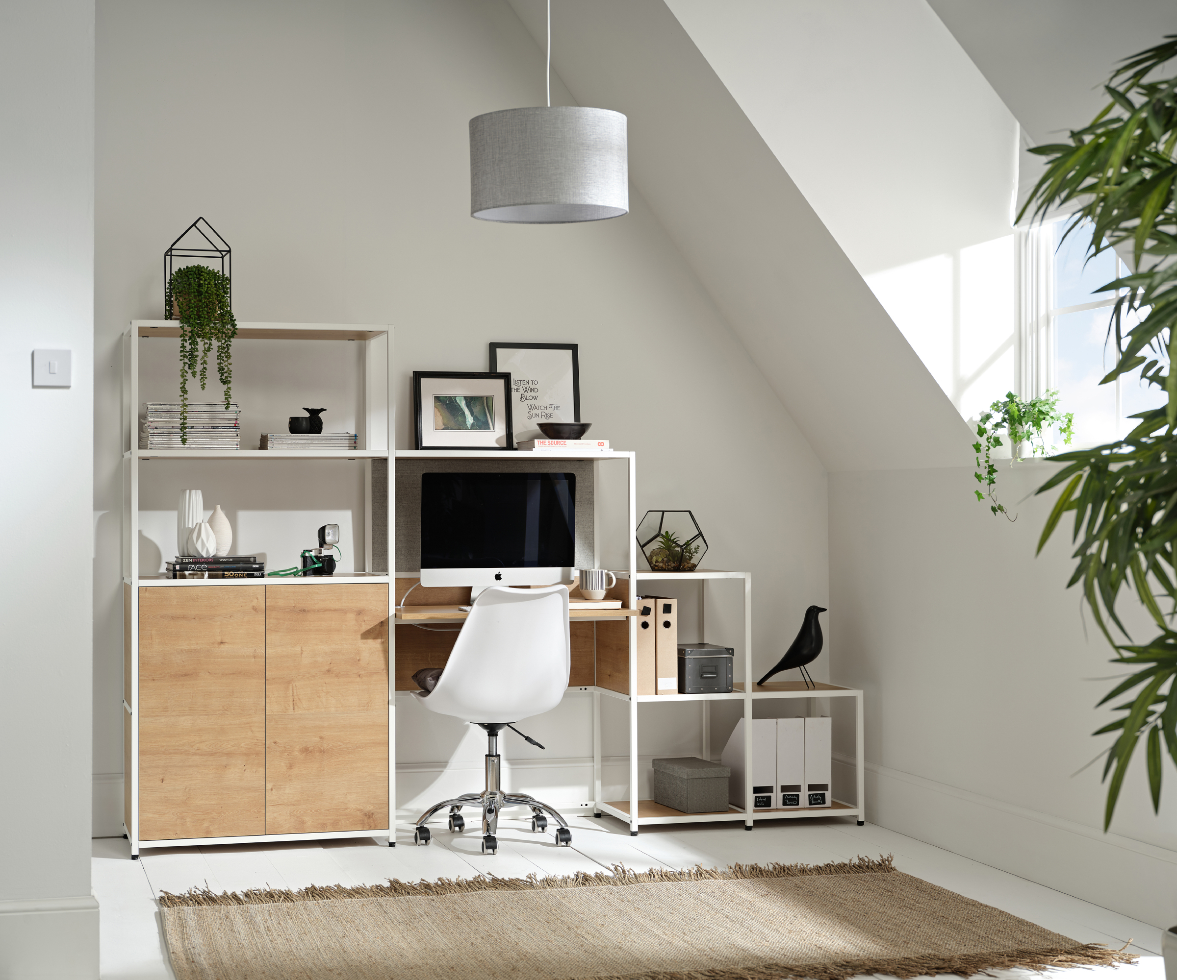 modular shelving system being used a desk in corner of loft