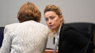 Amber Heard conferring with her legal team