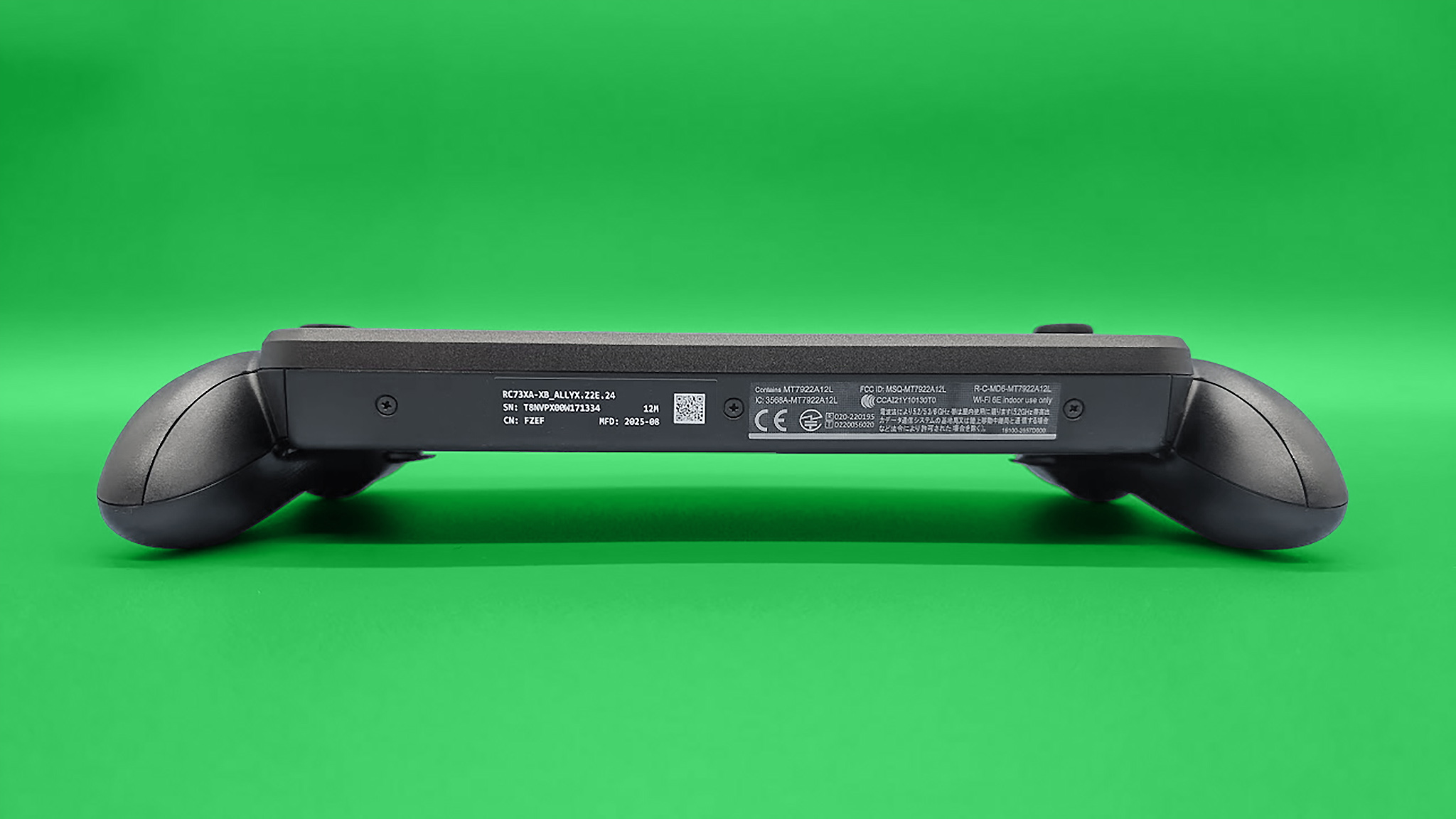 The ROG Xbox Ally X laying down with the bottom of the handheld visible.