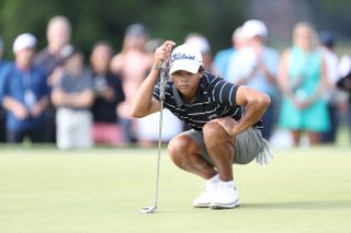 Charlie Woods lines up a putt at the US Junior Amateur