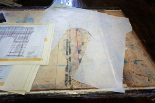 Plans and architectural drawings in Christo's studio, seen in a colour photograph