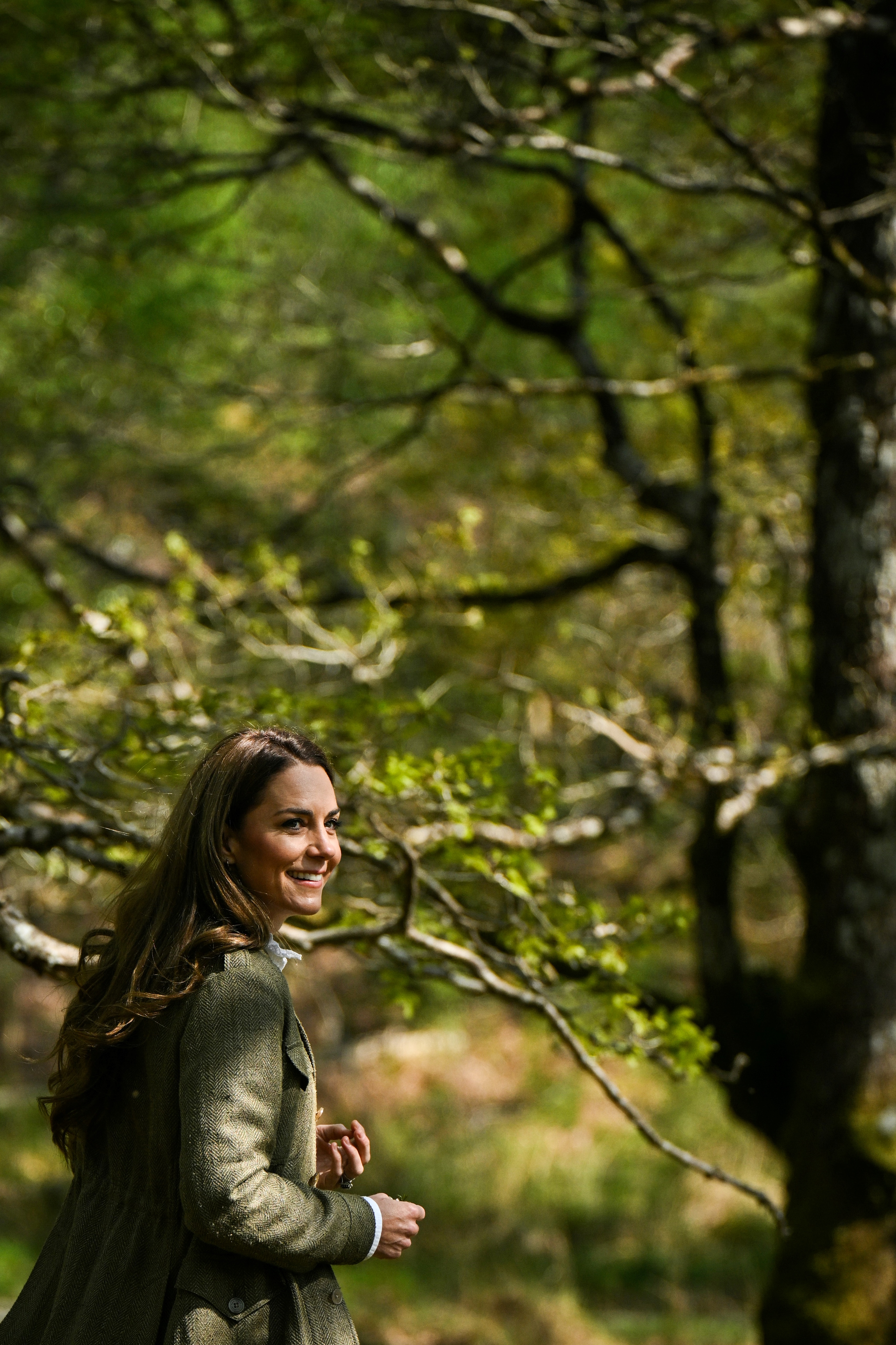 Kate Middleton seen in the countryside posing in the glowing sun while wearing a tweed jacket and a white shirt
