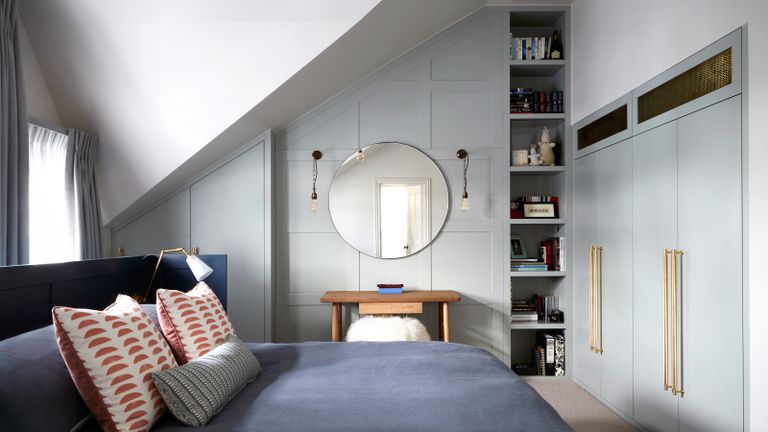 an attic bedroom space with built in storage