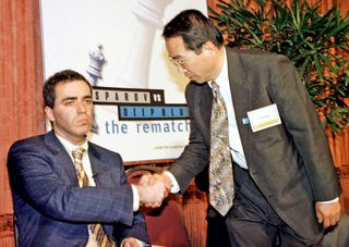 World Chess champion Garry Kasparov barely acknowledges the handshake from Dr. C.J. Tan head of the IBM Deep Blue computer team which defeated Kasparov in the six-game series that ended on May 11, 1997.