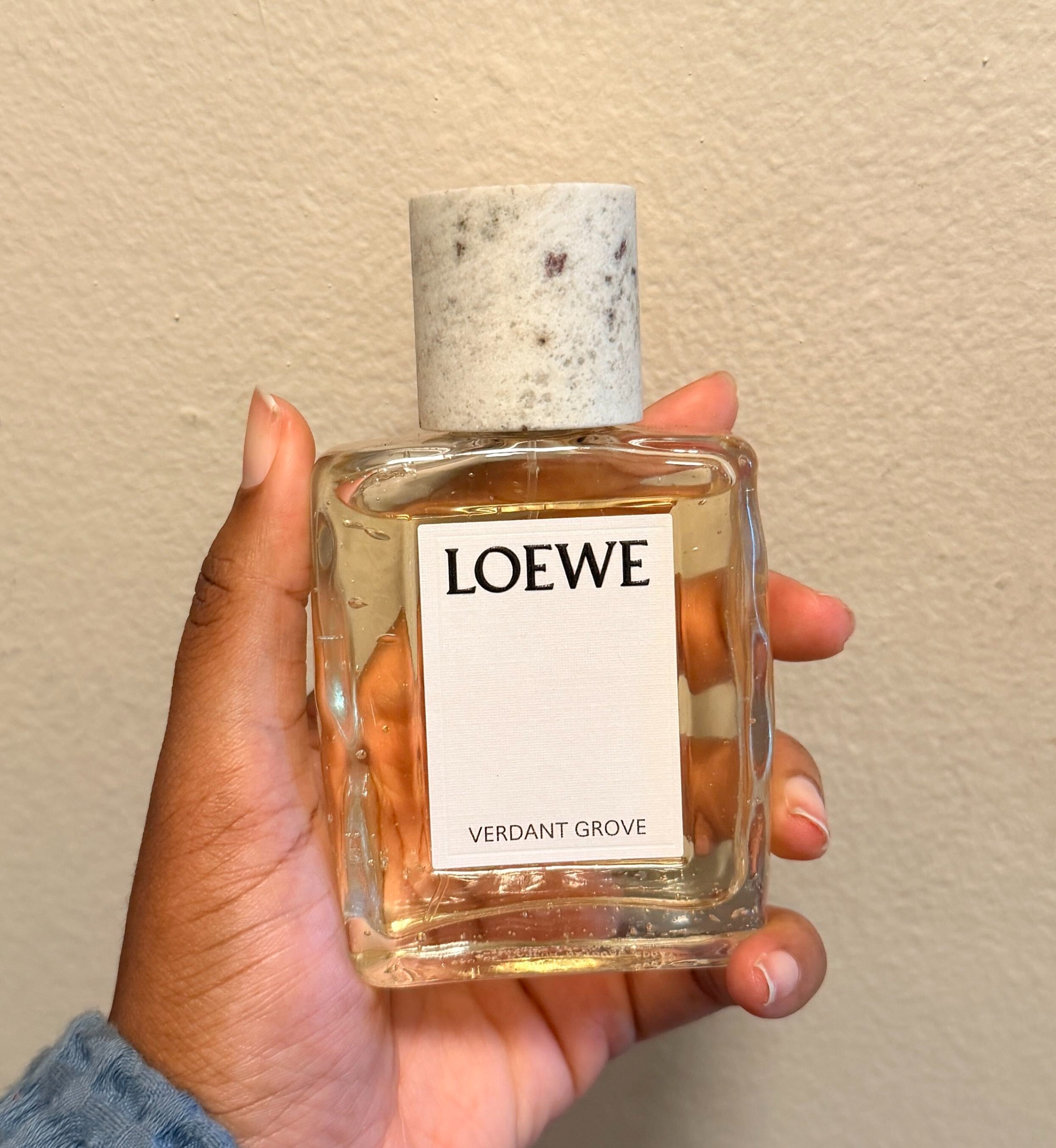 An image of Ariel holding Loewe Verdant Grove.
