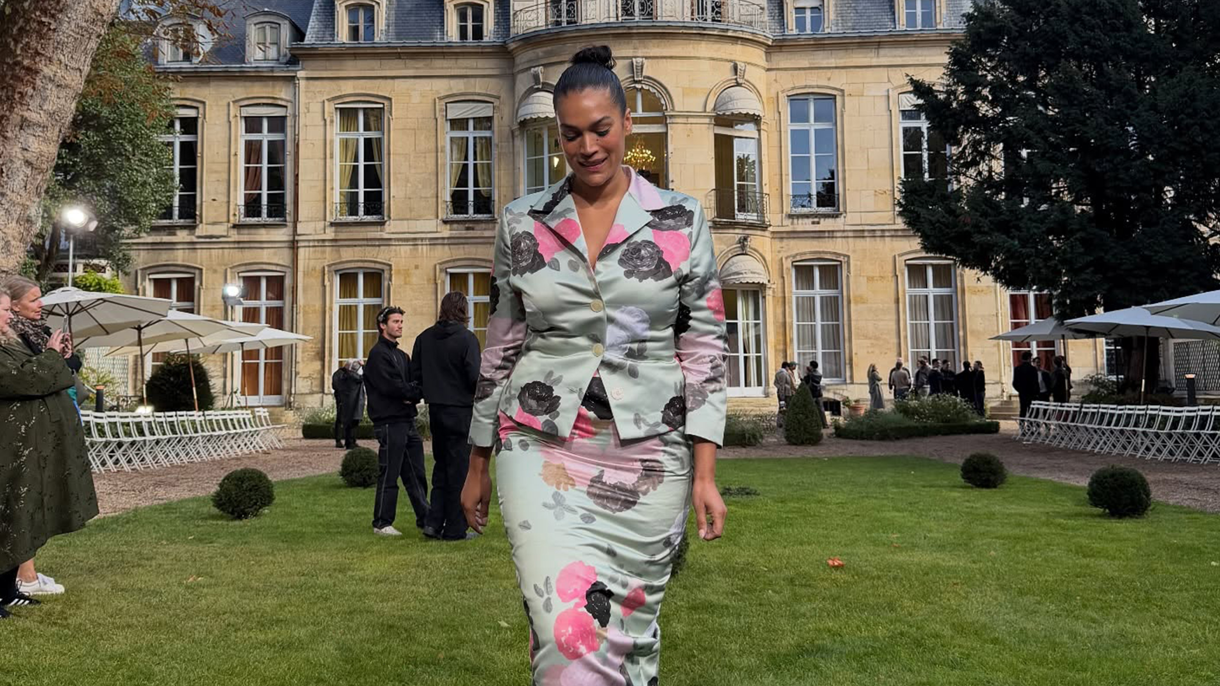 Jennifer Atilemile wearing a patterned skirt suit.