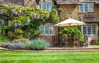 Patio furniture outside a Georgian Lodge.