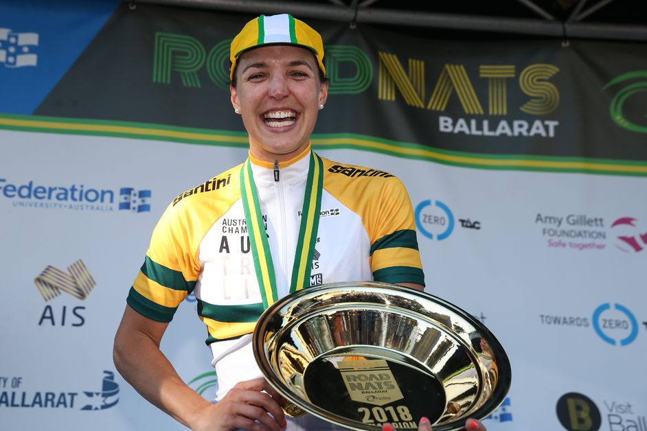 Rebecca Wiasak all smiles atop the podium