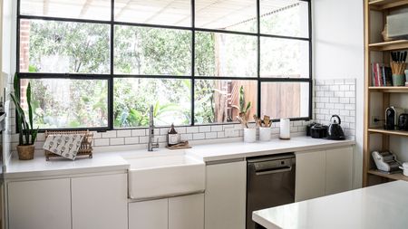 Interior view of modern kitchen with worktop sink and shelf 