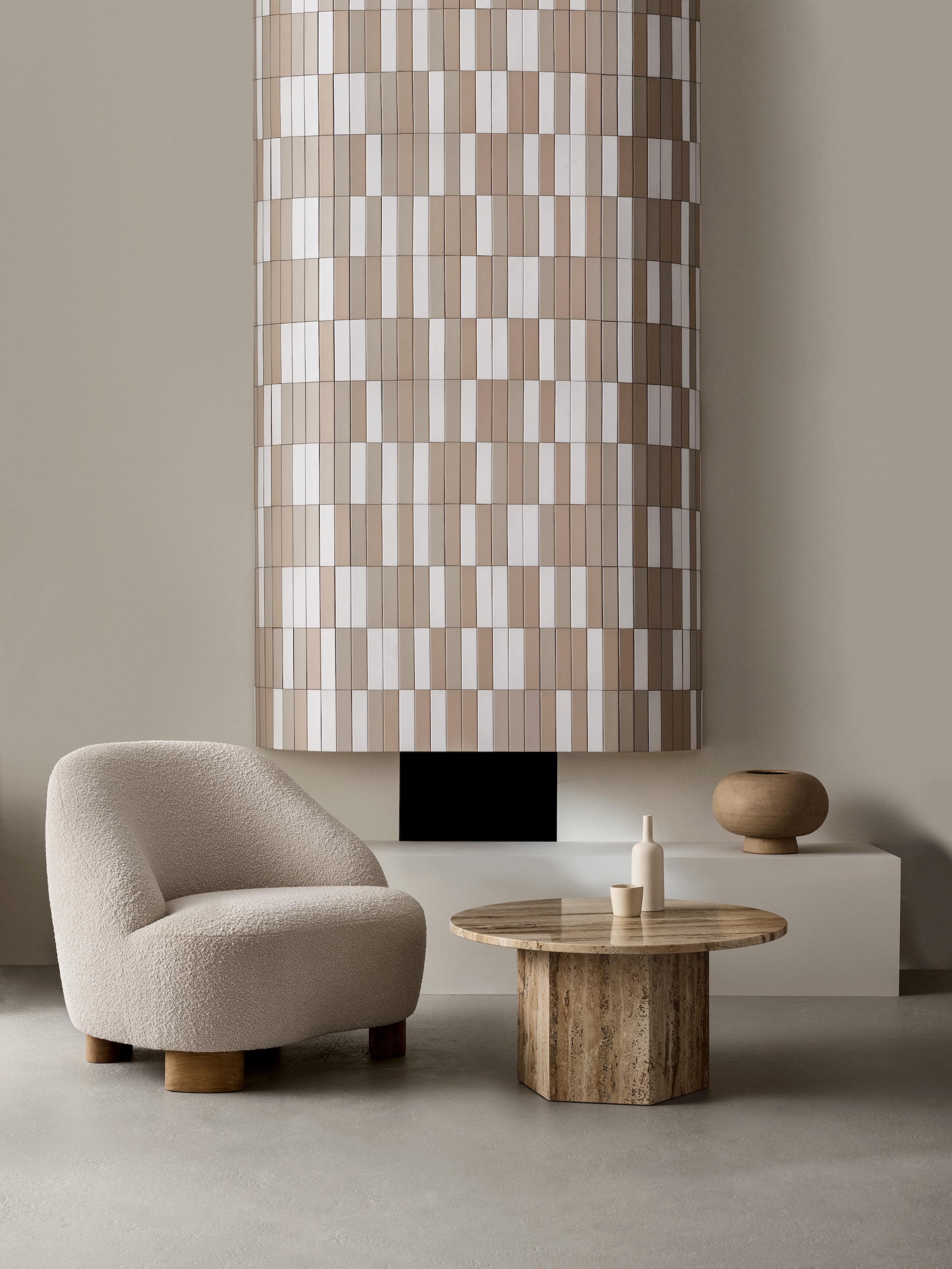 A modern living room with brown and white vertical tiles creating a feature chimney breast wall