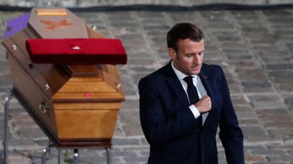 Emmanuel Macron pays his respects by the coffin of Samuel Paty's inside Sorbonne University's, Paris.