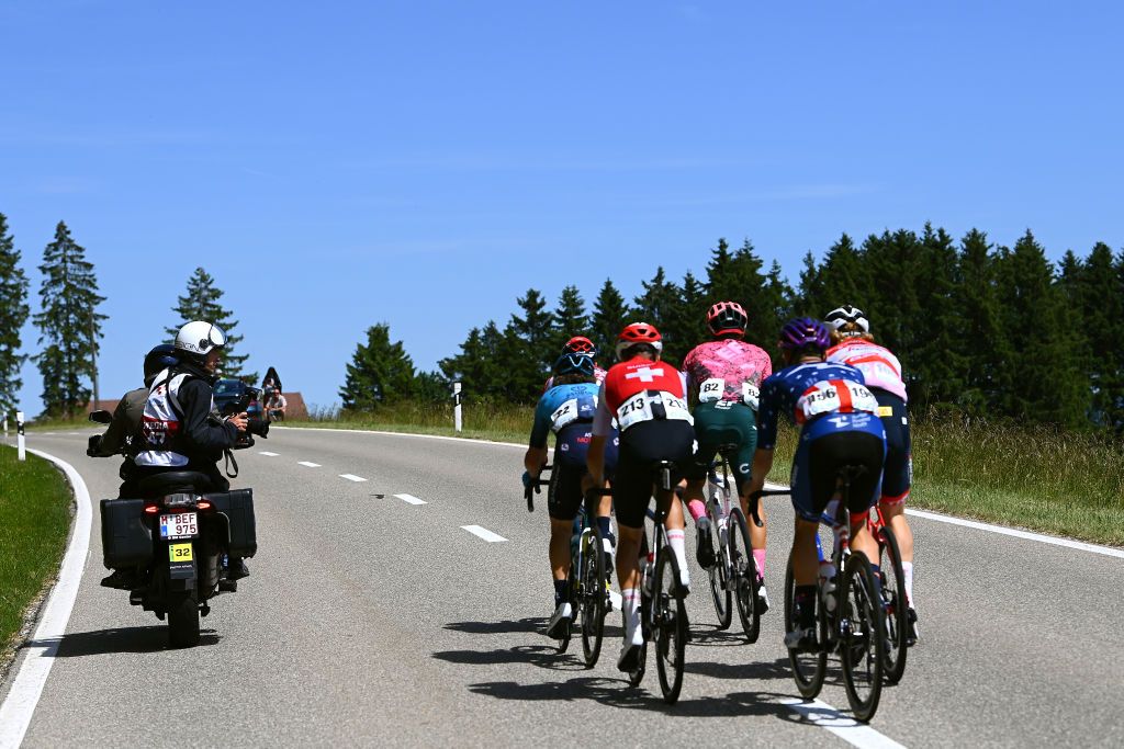GRENCHEN SWITZERLAND JUNE 14 A photographer works close to Manuele Boaro of Italy and Team Astana Qazaqstan Stefan Bissegger of Switzerland and Team EF Education Easypost Philippe Gilbert of Belgium and Team Lotto Soudal Quinn Simmons of United States and Team Trek Segafredo Red Mountain Jersey Joey Rosskopf of United States and Team Human Powered Health and Matthias Reutimann of Switzerland and Team Switzerland whilst competing in the breakaway during the 85th Tour de Suisse 2022 Stage 3 a 1769km stage from Aesch to Grenchen ourdesuisse2022 WorldTour on June 14 2022 in Grenchen Switzerland Photo by Tim de WaeleGetty Images