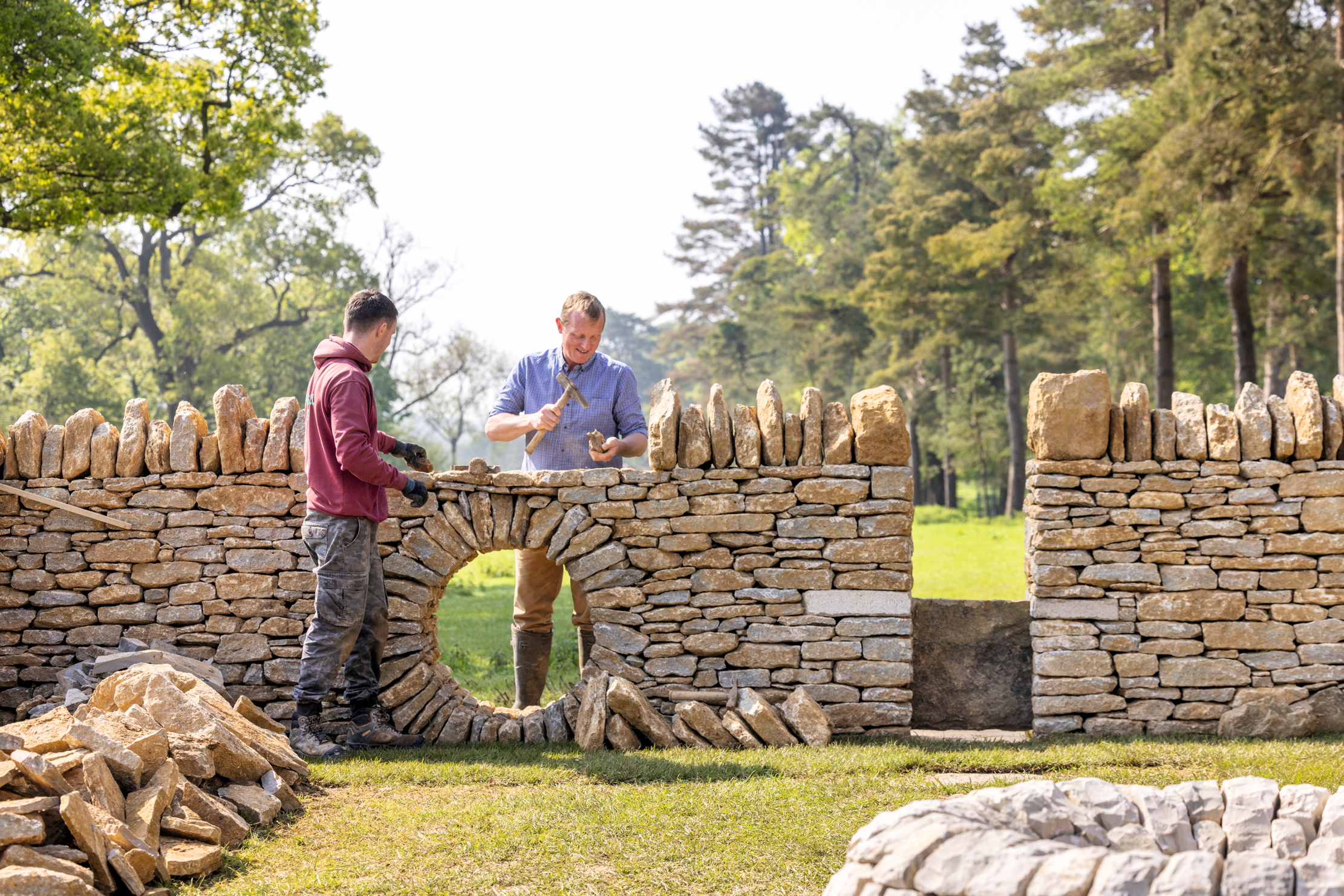 Art in stone: Liam Brady and Tom Trouton tap a new wall into existence at The Newt.