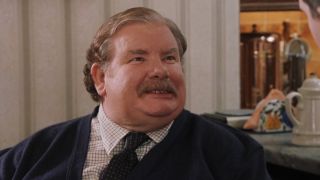 Vernon Dursley argues at the kitchen table.