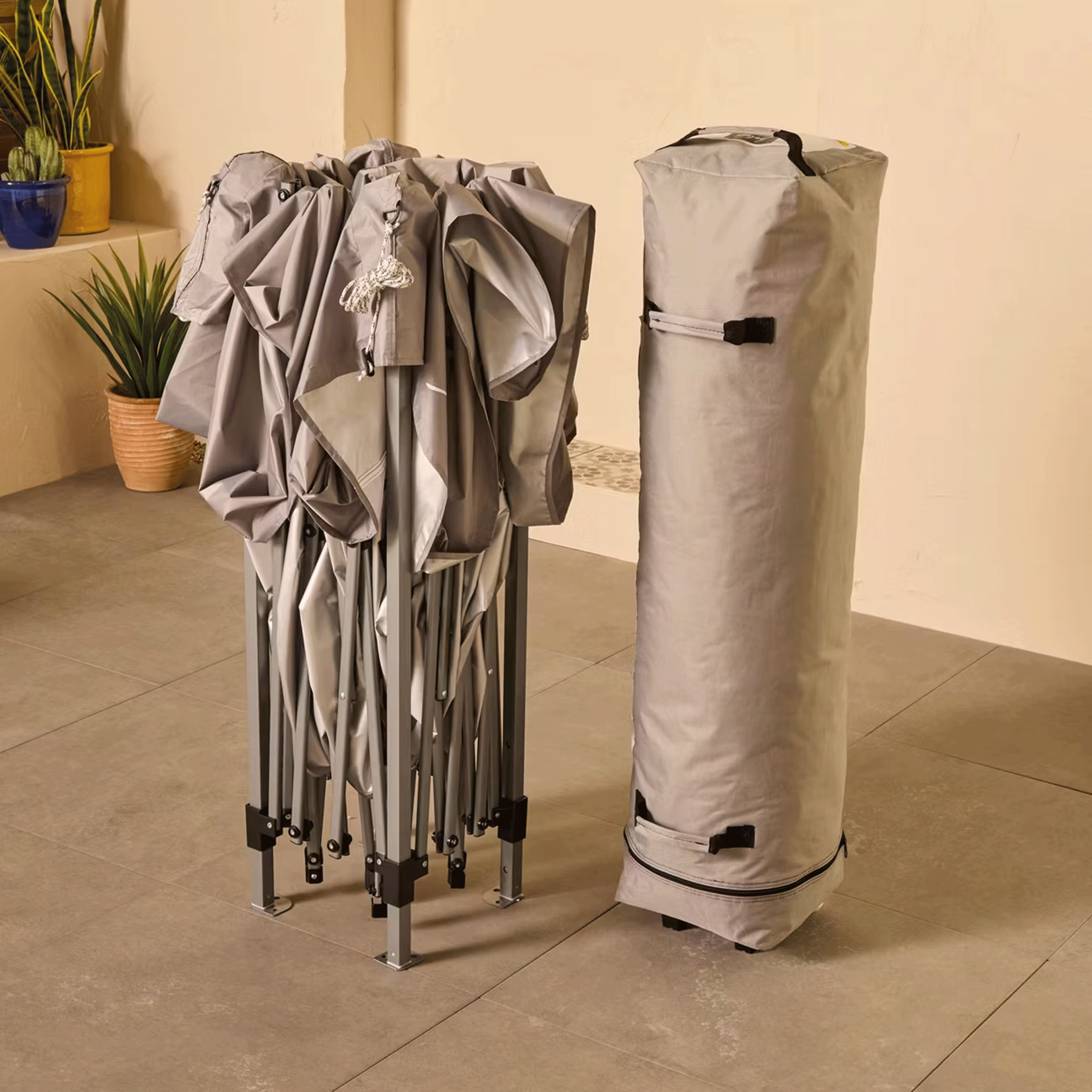 Aldi canopy folded up next to the storage bag on a patio