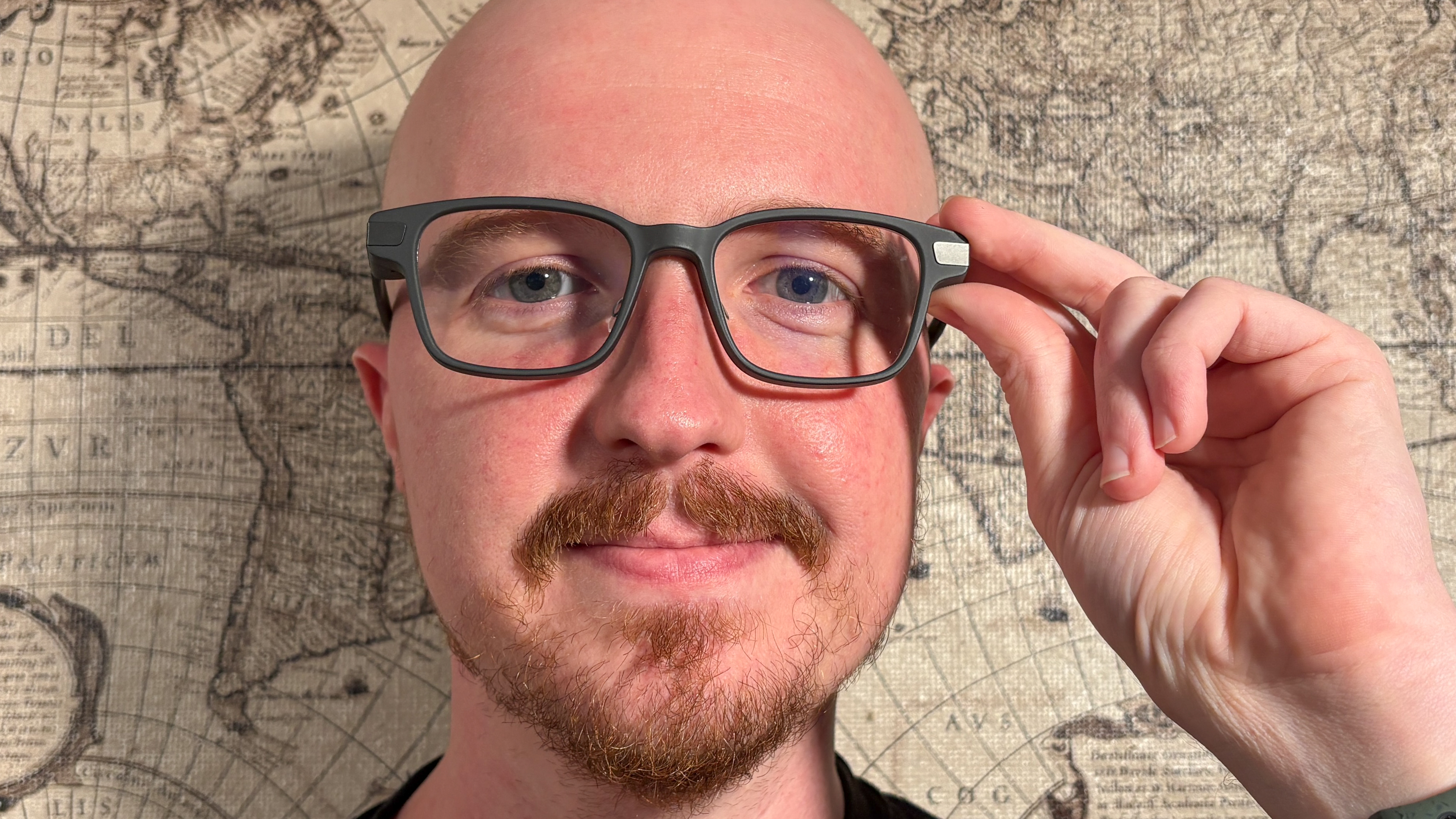 Even Realities G1 Smart Glasses worn by person with fingers touching temple with map in background