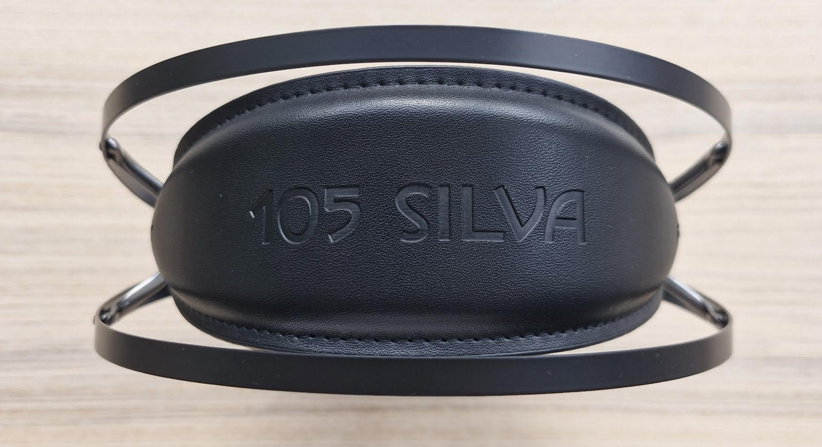 Meze Audio 105 Silva headphones on a light wooden table