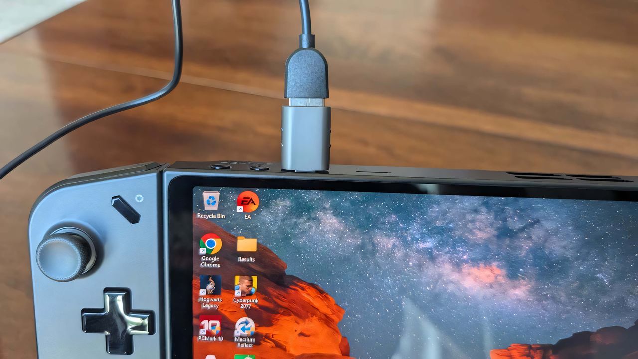 A Syntech USB-C to USB-A adapter sticking out of the top of a Lenovo Legion Go.