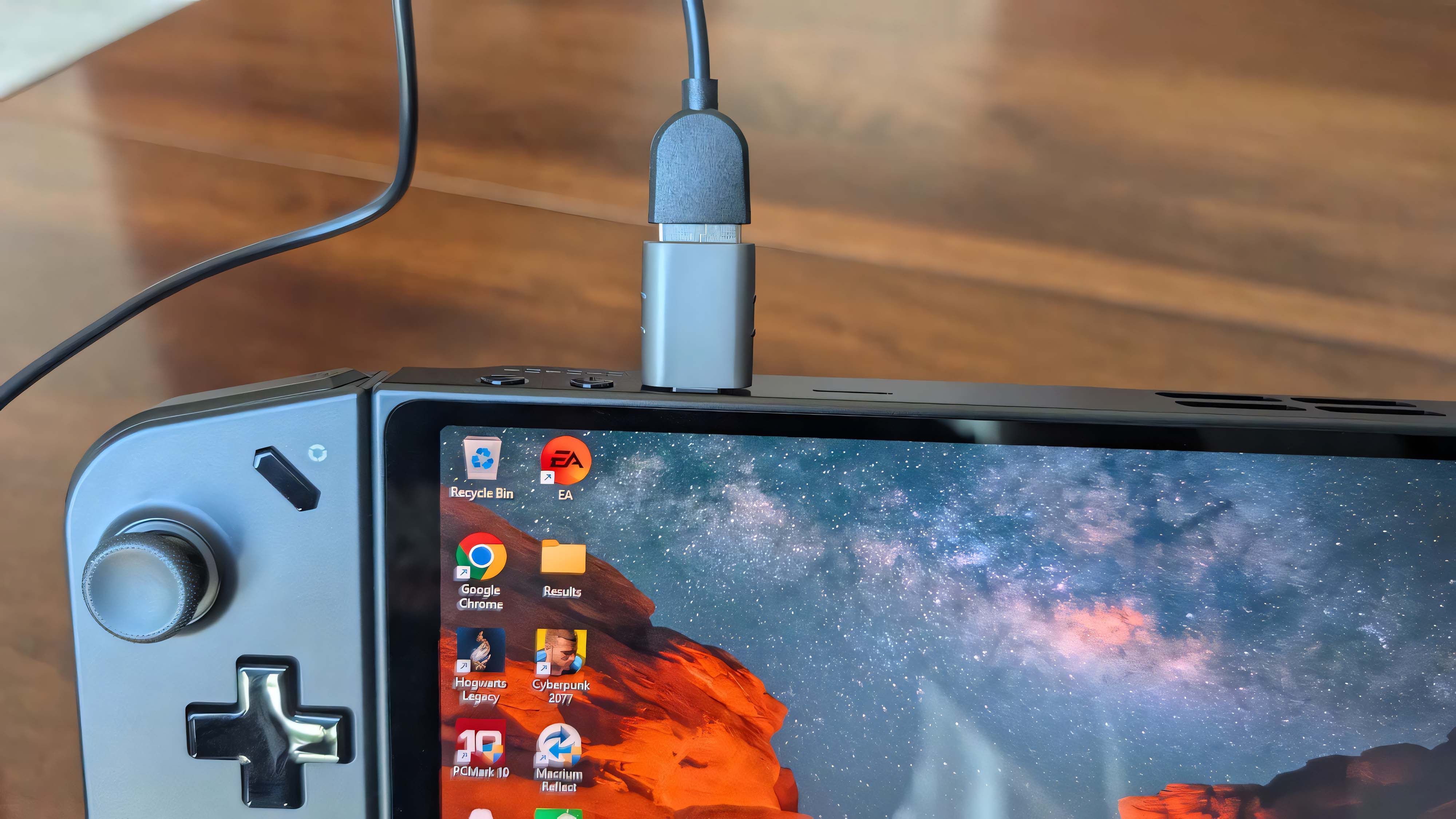 A Syntech USB-C to USB-A adapter sticking out of the top of a Lenovo Legion Go.