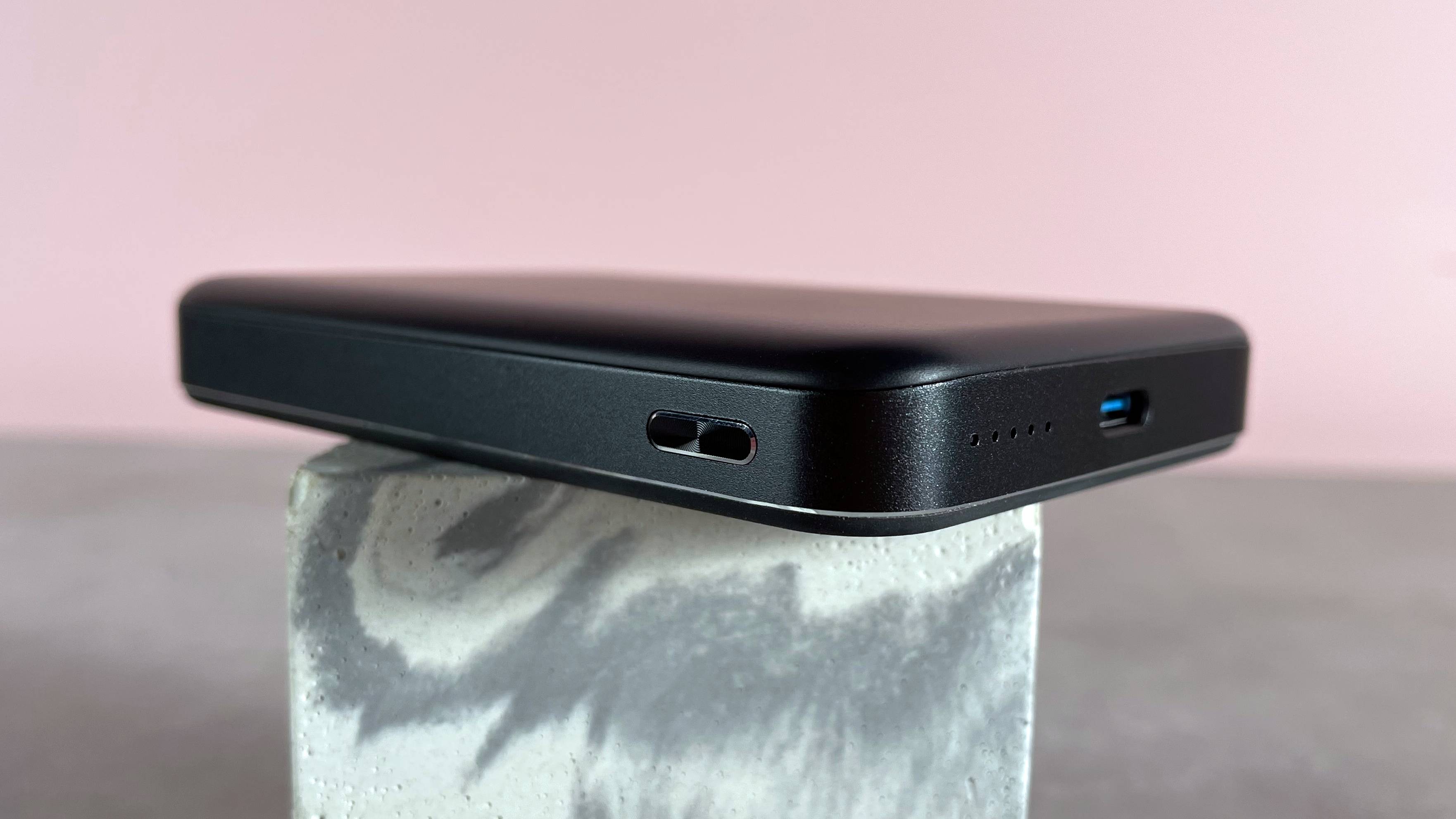 A view of the slim depth of the power bank, the textured button, and the USB-C port can be seen.