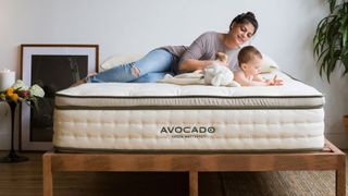 Woman lying on mattress with baby