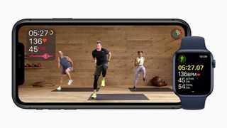Apple Watch Fitness+ on smartphone next to Apple Watch Series 6