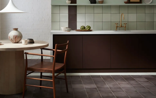 Brown kitchen cabinets with purple floor tiles and aqua marine wall tiles