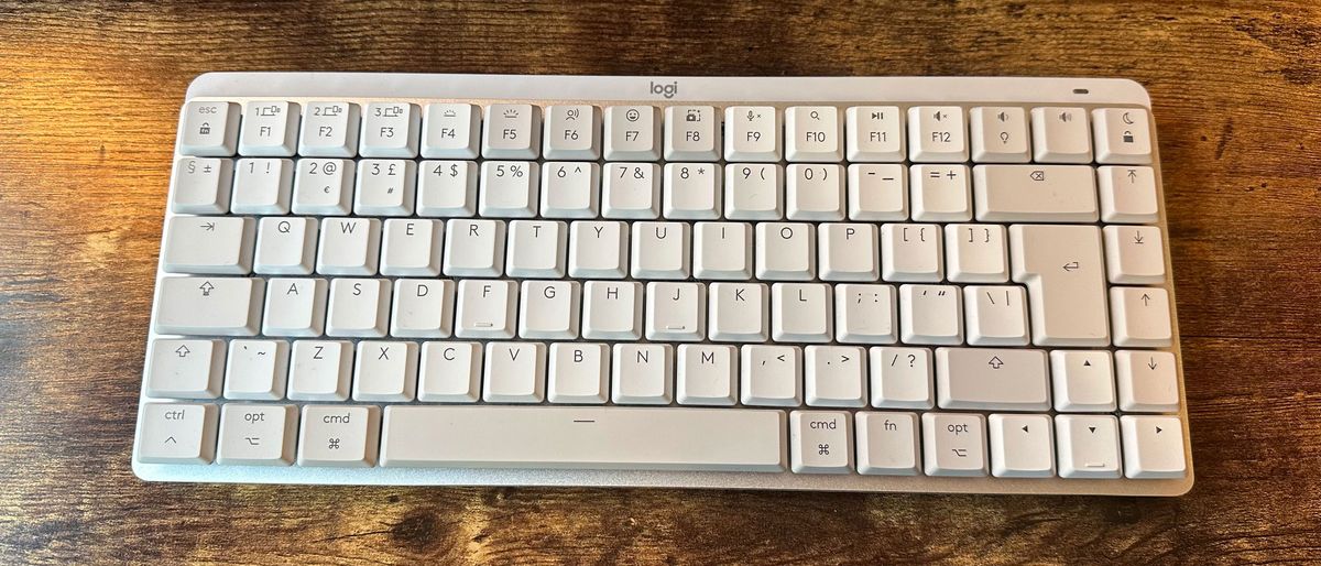 The Logitech MX Mechanical Mini for Mac on a wooden desk