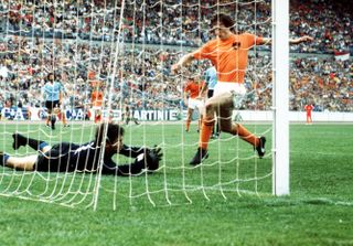 Uruguay goalkeeper Ladislao Mazurkiewicz dives to make a save from Netherlands captain Johan Cruyff at the 1974 World Cup