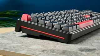 A black Lemokey X3 wired gaming keyboard with red keycaps