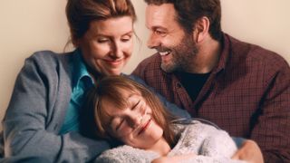 Best Interests key art featuring Nicci (Sharon Horgan), Marnie (Niamh Moriarty) and Andrew (Michael Sheen) huddled together.