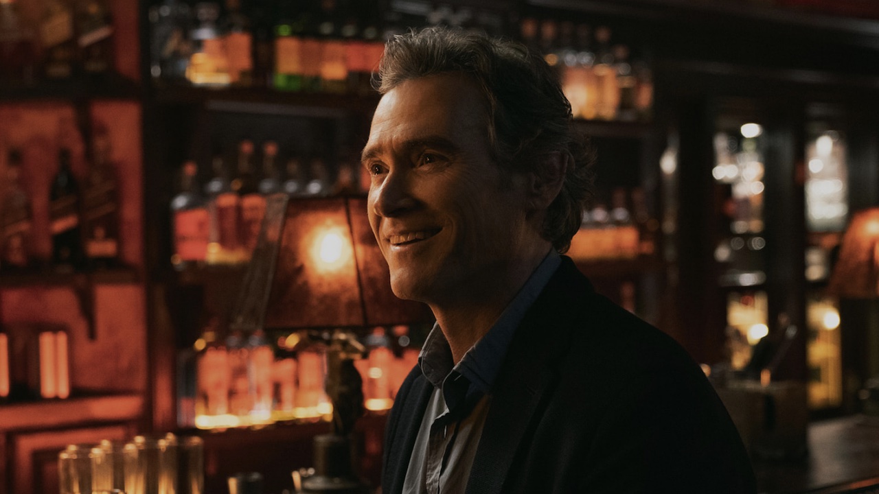 Billy Crudup smiling at a bar in The Morning Show Season 4.
