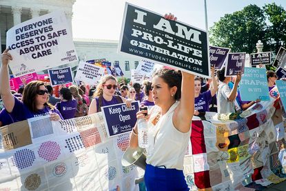 Pro-life and pro-choice activists outside the U.S. Supreme Court in June