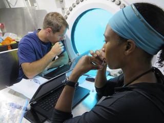 European Space Agency astronaut Thomas Pesquet (left) and NASA astronaut Jeanette Epps perform experiments during the NEEMO 18 mission in July 2014.