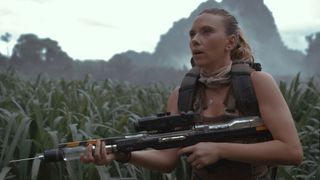 Scarlett Johansson's Zora holding a tranquilizer rifle in Jurassic World Rebirth