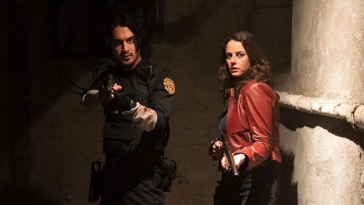 Leon and Claire wielding their firearms as they move down a corridor towards the camera