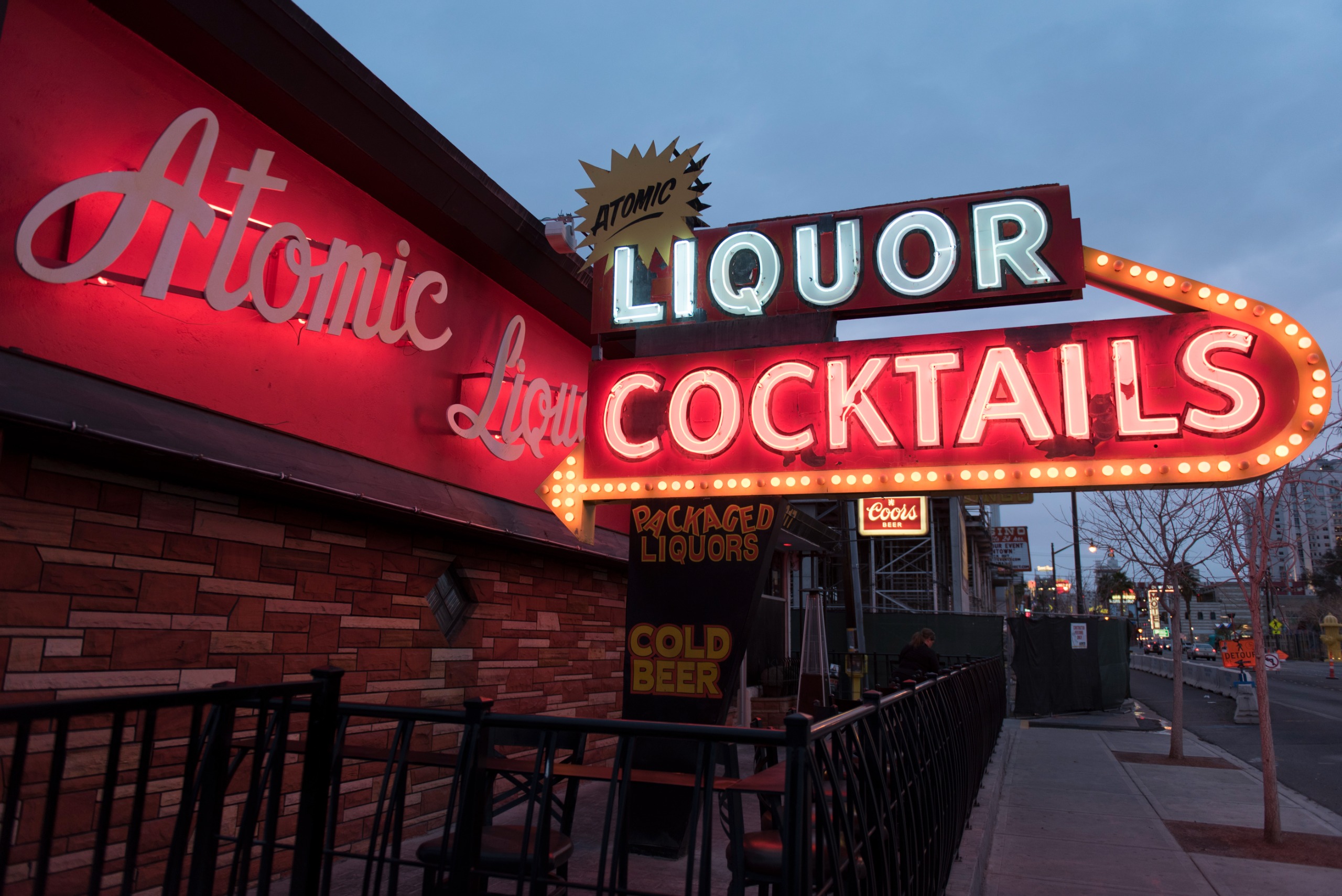 Atomic Liquors sign lit up at night