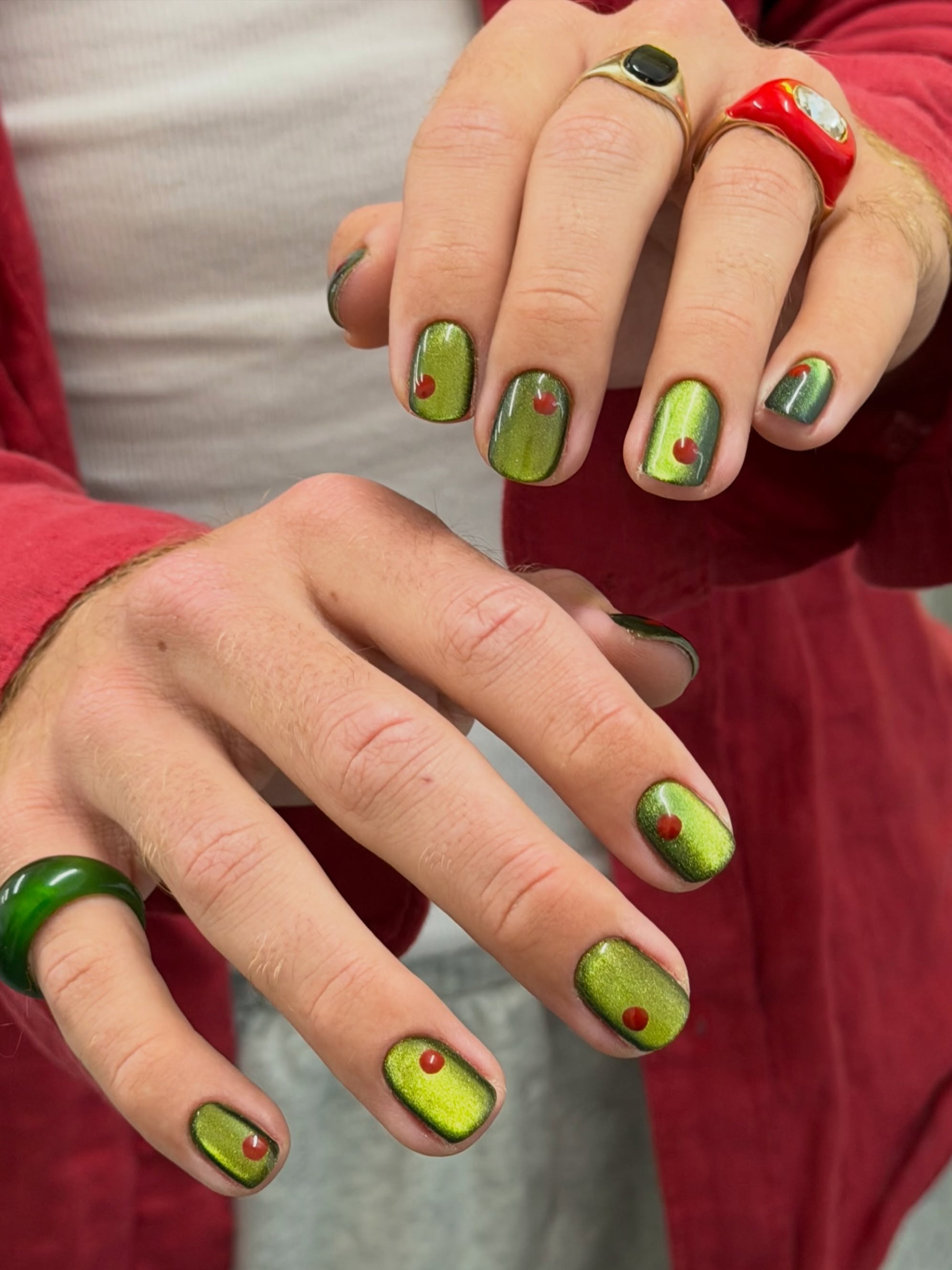 a glossy olive green shade on every nail with olive seeds