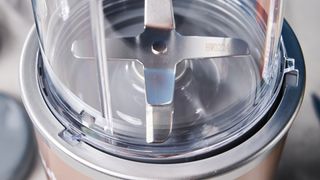 a champagne metallic beige blender with a 7 inch blending base is photographed against a blue background