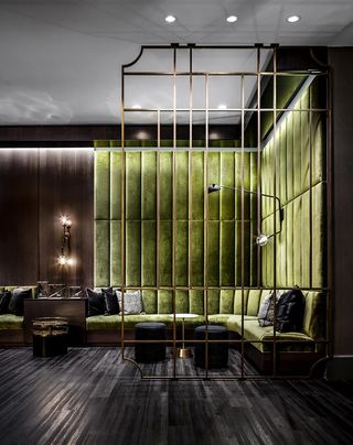 corner seating area with green velvet wall