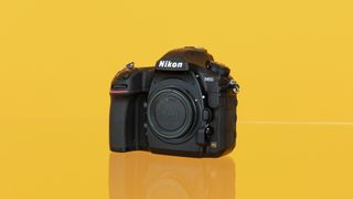 Nikon D850 camera on yellow background