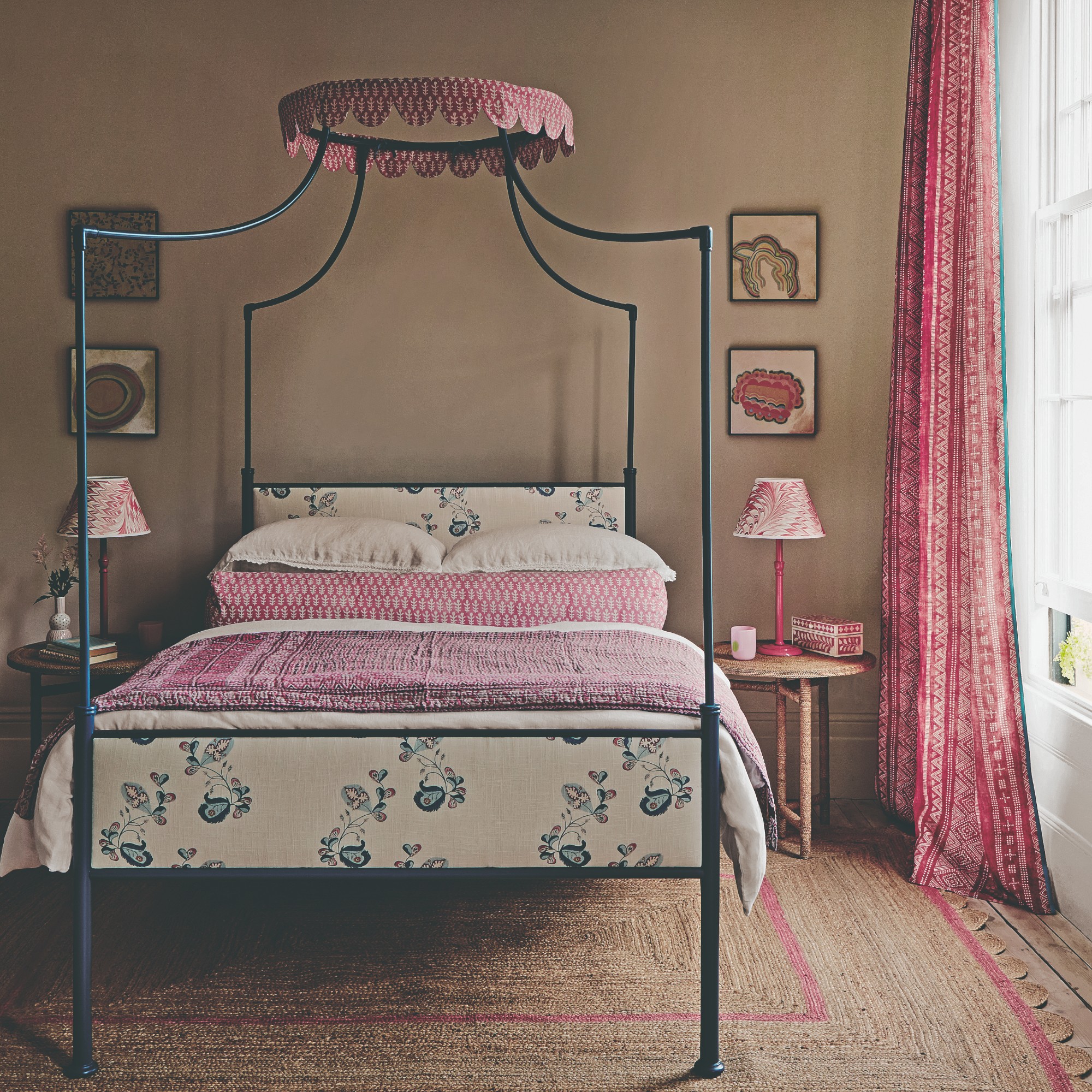 A beige-painted bedroom with a canopy bed and pink accents