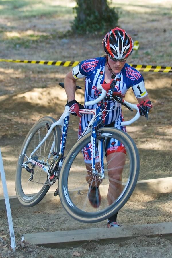 Katie Compton showing her world-class style on the run-up on the hilly course in Covington Kentucky&rsquo;s Devou Park. The hill, though not the steepest on the course, had steps built into it with railroad ties.