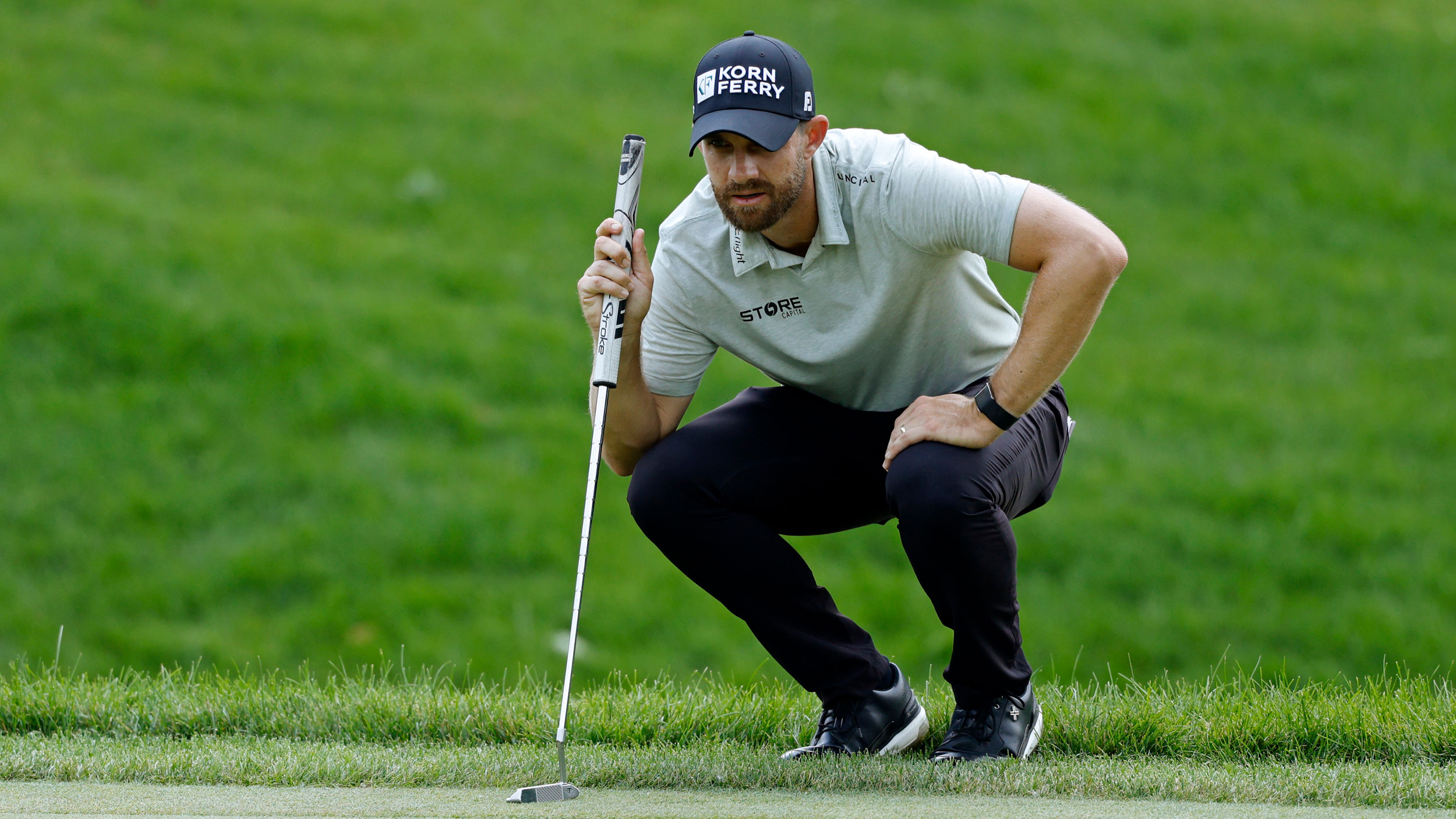 Patrick Rodgers crouches down behind a putt during the Memorial Tournament in 2026