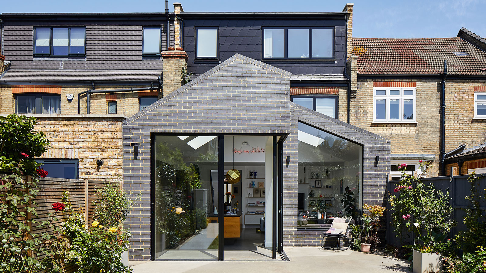 brick-clad rear extension with large sliding doors and a loft conversion